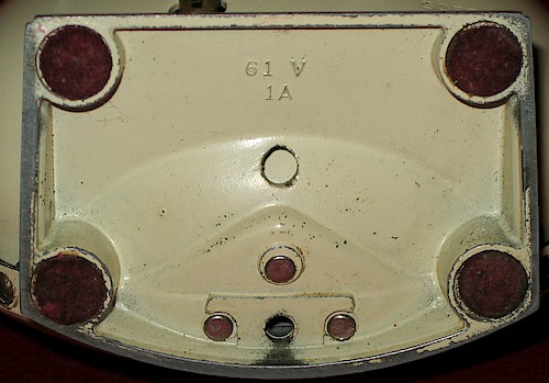 1 61V. Small lettering (about 1.8 mm tall), 2 holes in base, riveted to bezel. 1A or 2A. Solid base only. ca. 1949 - 1951.. Base 1, 1A