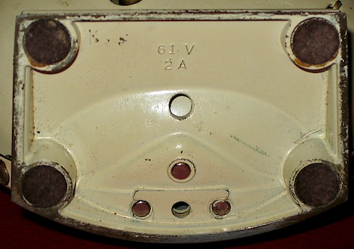 1 61V. Small lettering (about 1.8 mm tall), 2 holes in base, riveted to bezel. 1A or 2A. Solid base only. ca. 1949 - 1951.. Base 1, 2A