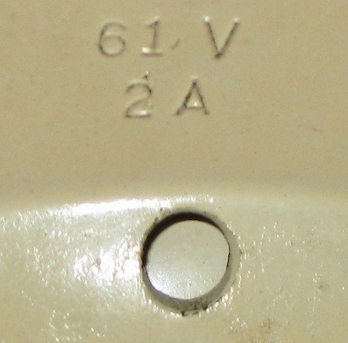 1 61V. Small lettering (about 1.8 mm tall), 2 holes in base, riveted to bezel. 1A or 2A. Solid base only. ca. 1949 - 1951.. Base 1, 2A