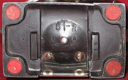 1 "LD", Two Rectangle "61-R" in large lettering, "1 A" below it, "LD" at right angle in recessed rectangle on the right, empty recessed rectangle on left. Used 1941 - 1942. Clock is upright on base. ("2 A" not seen yet.). Base 1, LD, 2 Rectangle
