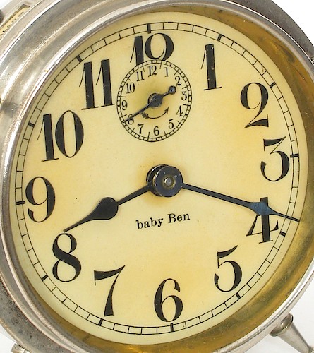 1.1 Celluloid covered paper, baby Ben below center with first "b" in lower case, back of "4" is curved, no lettering at bottom. 1912 - 1914. Note: Original dials are found today varying in color from slightly off-white to yellow. When new, they were slightly off-white. Notice that the back of the numeral 4 is curved and the thickness tapers. 1912 - 1913.. Dial 1.1. Richard Tjarks collection.