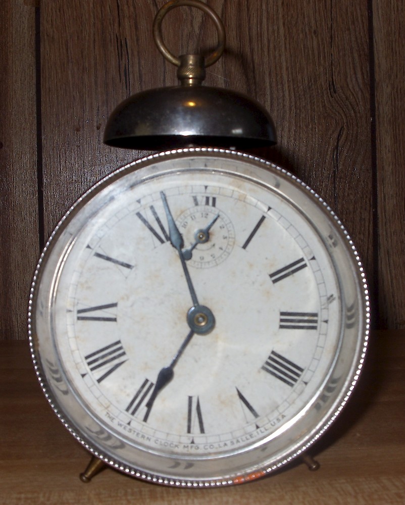 Westclox Daisy Enameled Alarm. Dial is labeled THE WESTERN CLOCK MFG. CO., LA SALLE, ILL., U.S.A.