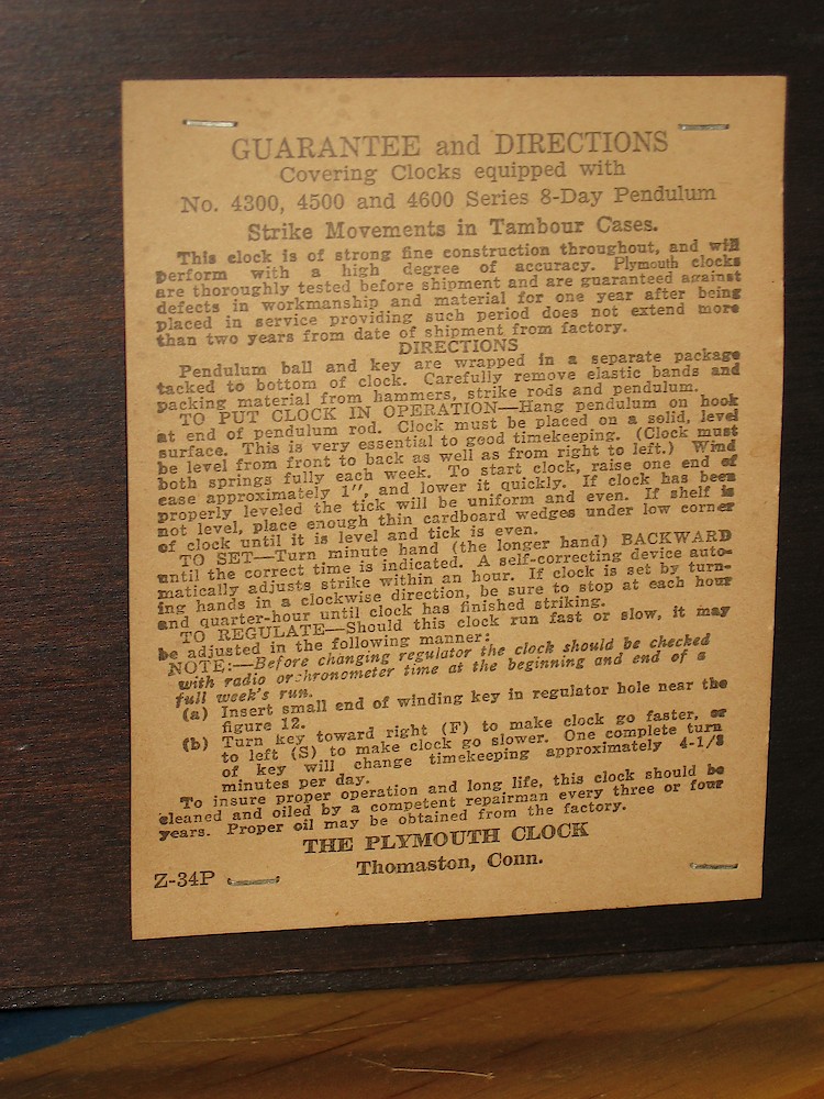 Plymouth Tambour Quarter Hour Strike 4601 Movement. Label inside back door. "Guarantee and Directions Covering clocks Equipped with No. 4300, 4500 and 4600 series 8-Day Pendulum Strike Movements in Tambour Cases."