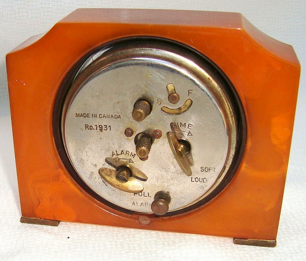 Seth Thomas Red Orange Catalin Alarm Luminous. The back says "Made in Canada, Rd. 1931".