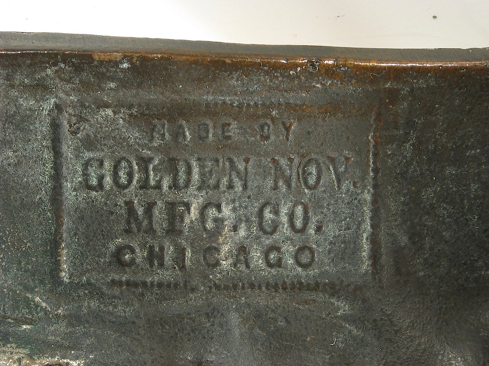 Golden Novelty Cherub And Flowers Cast Front. Name on back of case casrting Made by Golden Nov. Mfg. Co. Chicago (Nov. is Novelty)