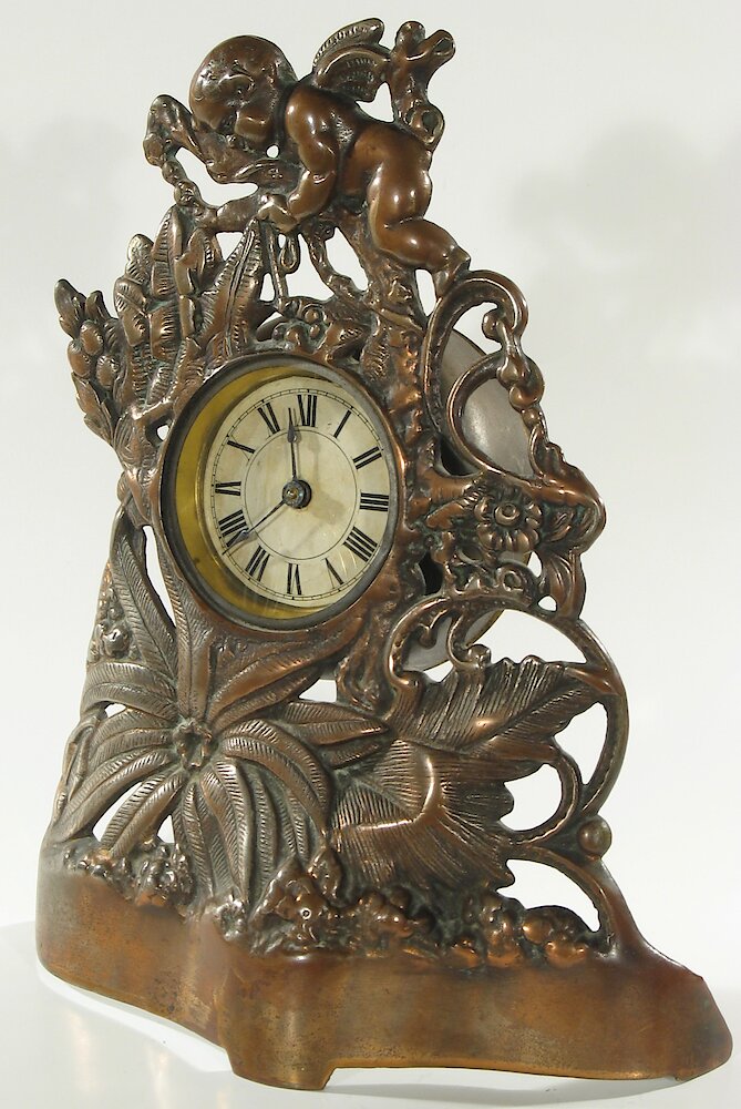 Golden Novelty Cherub And Flowers Cast Front. Golden Novelty Cherub And Flowers Cast Front Clock Example Photo