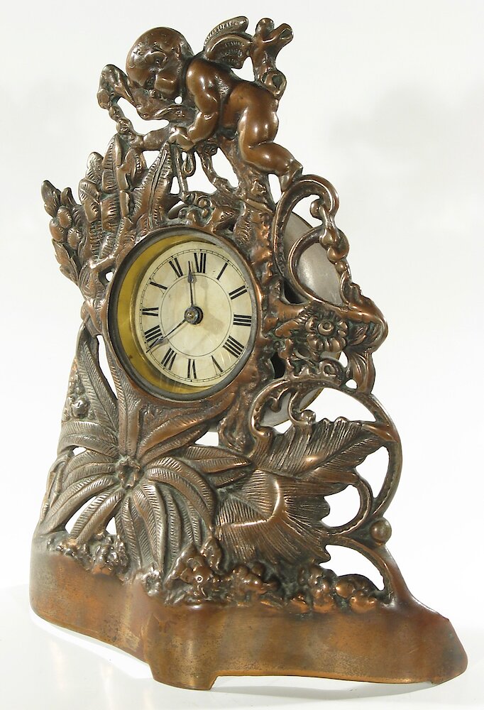 Golden Novelty Cherub And Flowers Cast Front. Golden Novelty Cherub And Flowers Cast Front Clock Example Photo