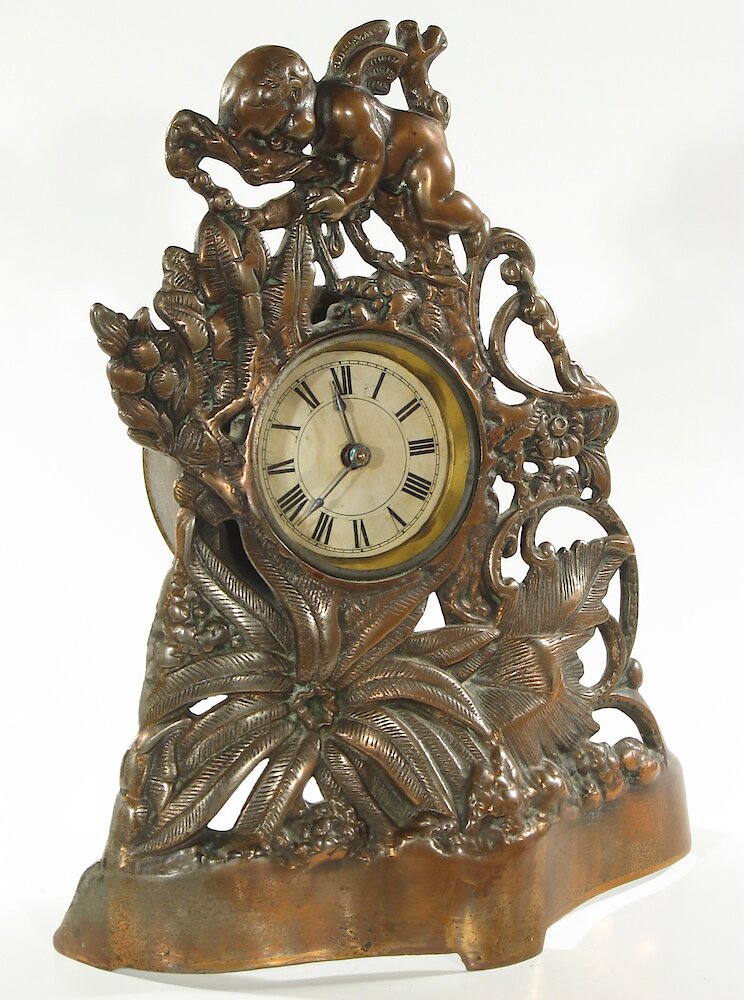 Golden Novelty Cherub And Flowers Cast Front. Golden Novelty Cherub And Flowers Cast Front Clock Example Photo