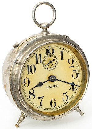 Westclox Baby Ben Style 1 Alarm Clock. Celluloid dial, lower case "b" in "baby": 1912 - 1914. Note: Original dials are found today varying in color from slightly off-white to yellow. When new, they were slightly off-white.

Notice that the back of the numeral 4 is curved and the thickness tapers.

Richard Tjarks collection.