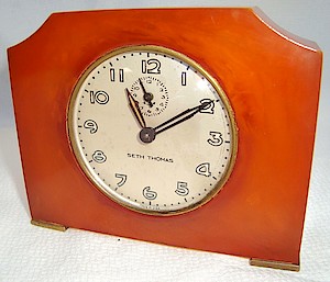 Seth Thomas Red Orange Catalin Alarm Luminous. Luminous dial says "Made in U.S.A." at bottom