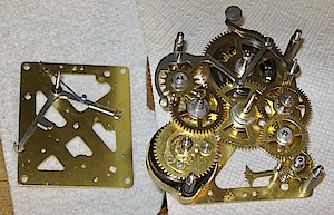 Westclox Big Ben Style 1 Nickel. Front and back plate, with their parts, ready for assembly. Next step is to turn over the front plate and assemble it to the back plate.