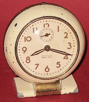 Westclox Baby Ben Style 5 Ivory Plain. Unusual example with steel bezel, aluminum back, brass movement with blued steel mainspring barrels.  The day is missing form the date stamp.