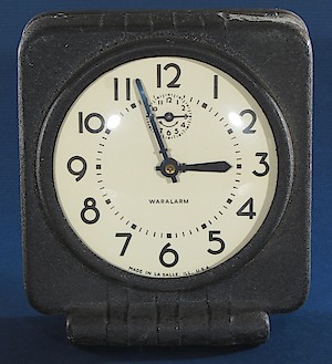 Westclox Waralarm Molded Fiber Case. Early example with price label and bell alarm (hole on left side of back is empty.) No movement date. Front plate is brass and back plate is steel. Minute hand has brass hub. Dial doesn't have lip around outer edge.