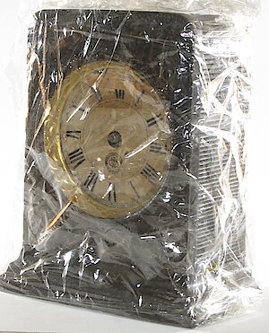 Westclox F W Gun Metal. Dial has round WC logo. Height 5 1/16" Includes pictures of movement. Back is missing so clock is wrapped in cling wrap.