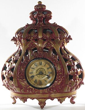 Swift Deemer Stove Clock Cast Iron. Case has been repainted red and gold.