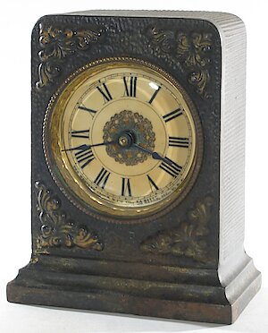 Westclox F W Gold Decorations Ivorine Dial. Height 5 1/8" May be an Ironclad, as it has the tall bottom step in the base.