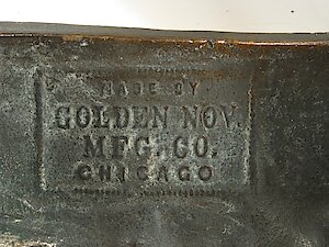 Golden Novelty Cherub And Flowers Cast Front. Name on back of case casrting. Made by Golden Nov. Mfg. Co. Chicago (Nov. is Novelty)