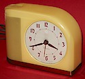 Gray dial with maroon numerals and hands.