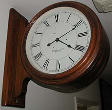 Double dial corridor clock in oak