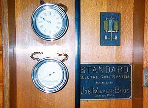 Installer's name plate attached to the back of an earlier master clock
