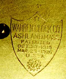 Close-up of movement of early table clock, showing the patent dates in a shield