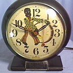 Fake clock with dial of a black figrure playing a bass drum. Made from a Big Ben style 5 electric alarm