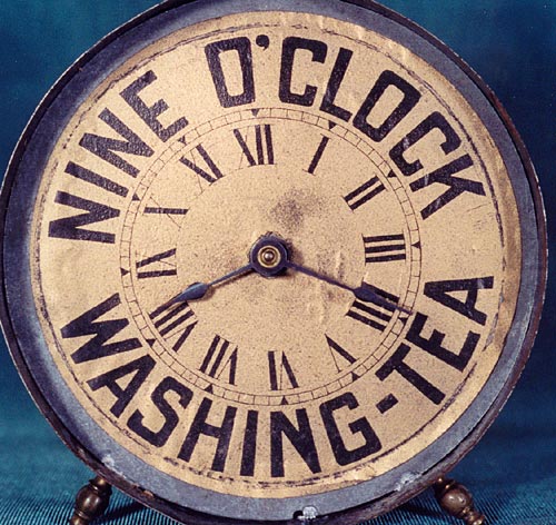Gold background dial of Nine O'clock Washing Tea advertising clock.
